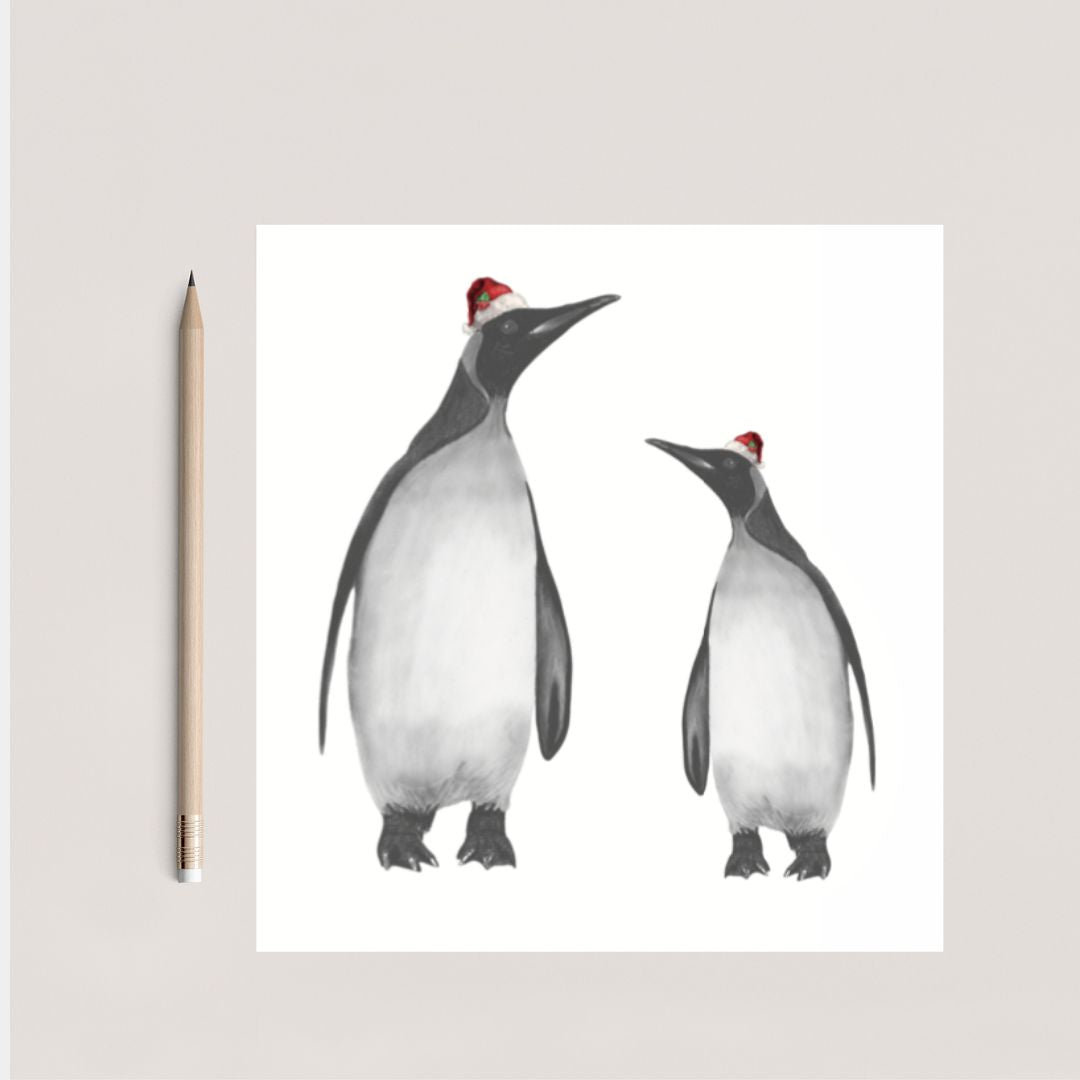 Cute hand-drawn penguin Christmas card featuring Alya and her baby with festive red hats