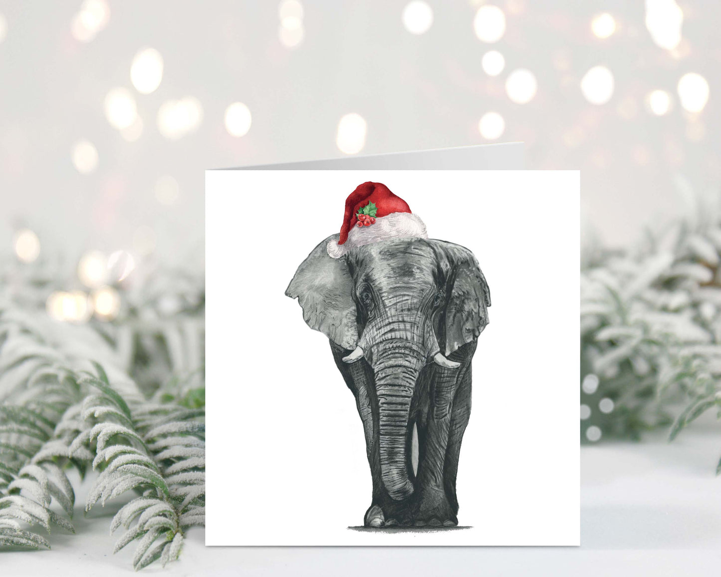 Atik the elephant wearing a Santa hat on a festive Christmas greeting card
