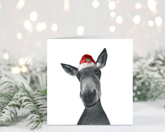 Hand-drawn Christmas card featuring Sirus the donkey wearing a festive Santa hat.