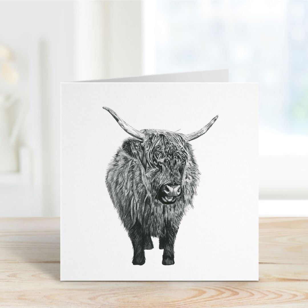 A charming hand-drawn baby Highland Cow greeting card, printed on Libra Fine Arts cardstock for a premium feel. The card is displayed open on a shelf, showcasing its high-quality texture and blank inside, perfect for a personal message. An ideal gift for Highland cow lovers, countryside enthusiasts, and special occasions like birthdays, baby showers, thank you notes, or just because.
