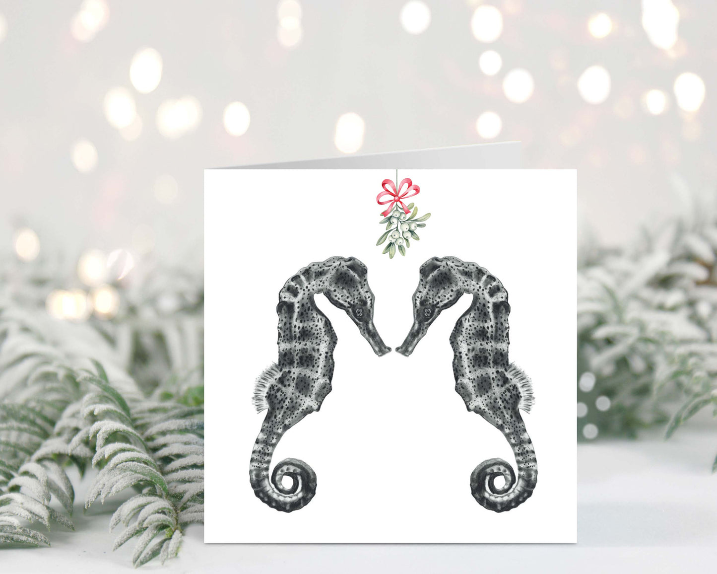 Diya the seahorse and friend under festive mistletoe on a charming Christmas greeting card