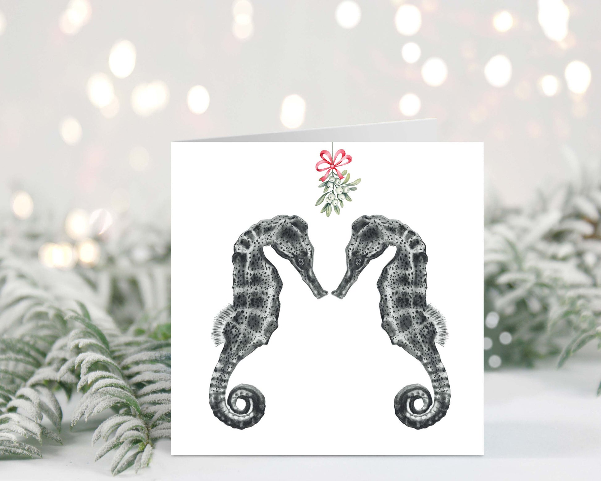 Diya the seahorse and friend under festive mistletoe on a charming Christmas greeting card