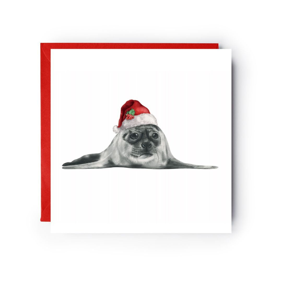 Charming Christmas greeting card featuring Ara the seal in a red Santa hat