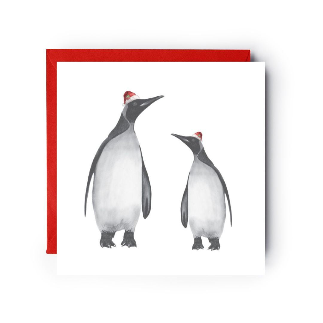 Adorable penguin Christmas card with Alya and her baby in red Santa hats, perfect for holiday greetings