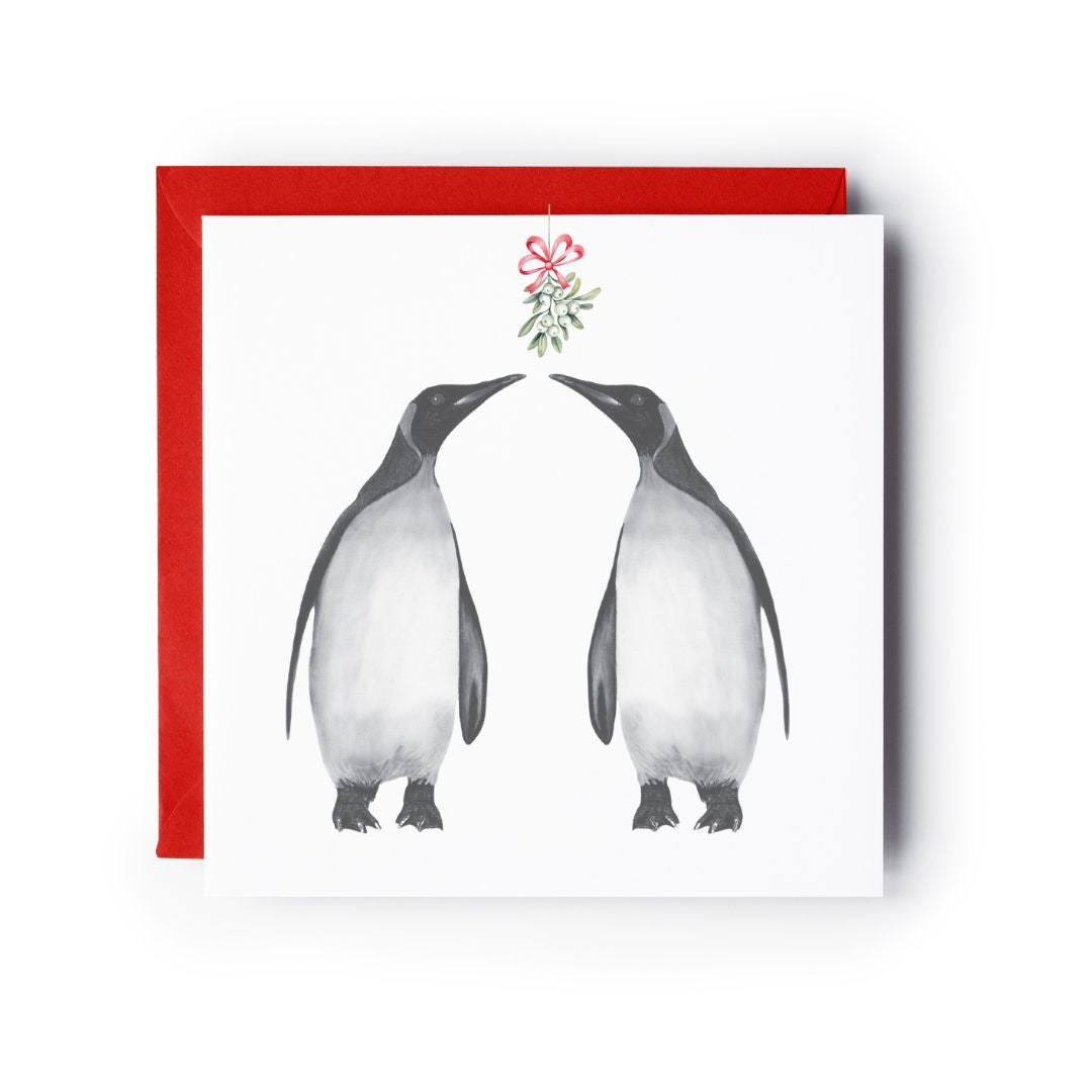 Adorable penguin illustration under mistletoe, perfect for a cozy Christmas card