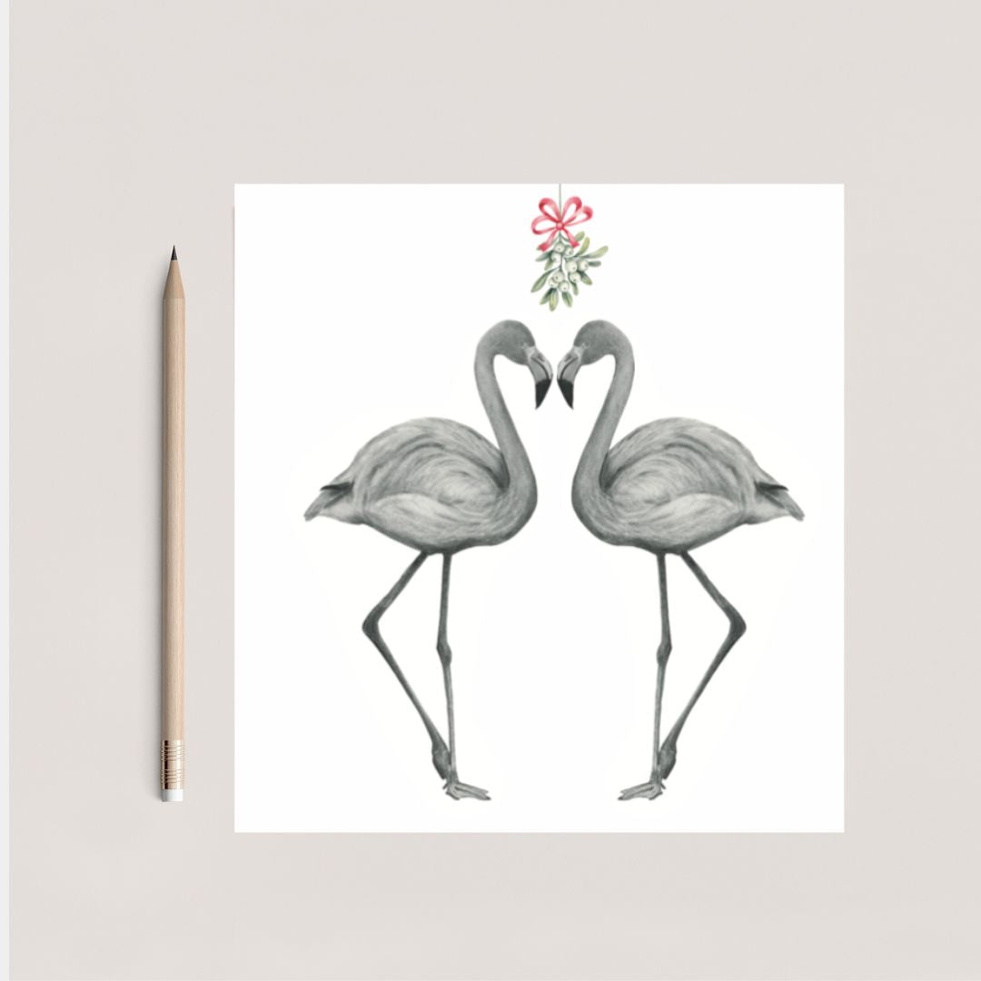 Hand-drawn festive flamingos sharing a kiss under the mistletoe, wearing red hats for a Christmas celebration.