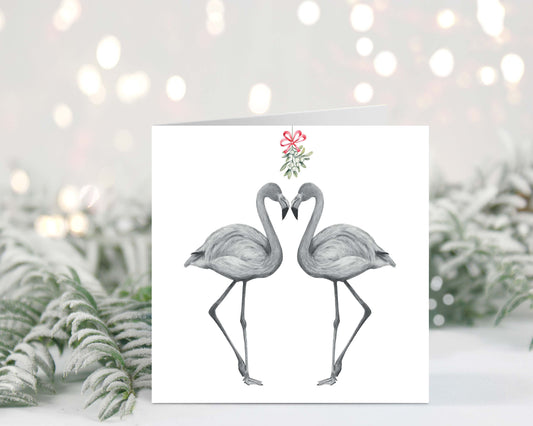 Flamingo couple sharing kisses under the mistletoe, festive red hats on, hand-drawn Christmas greeting card.