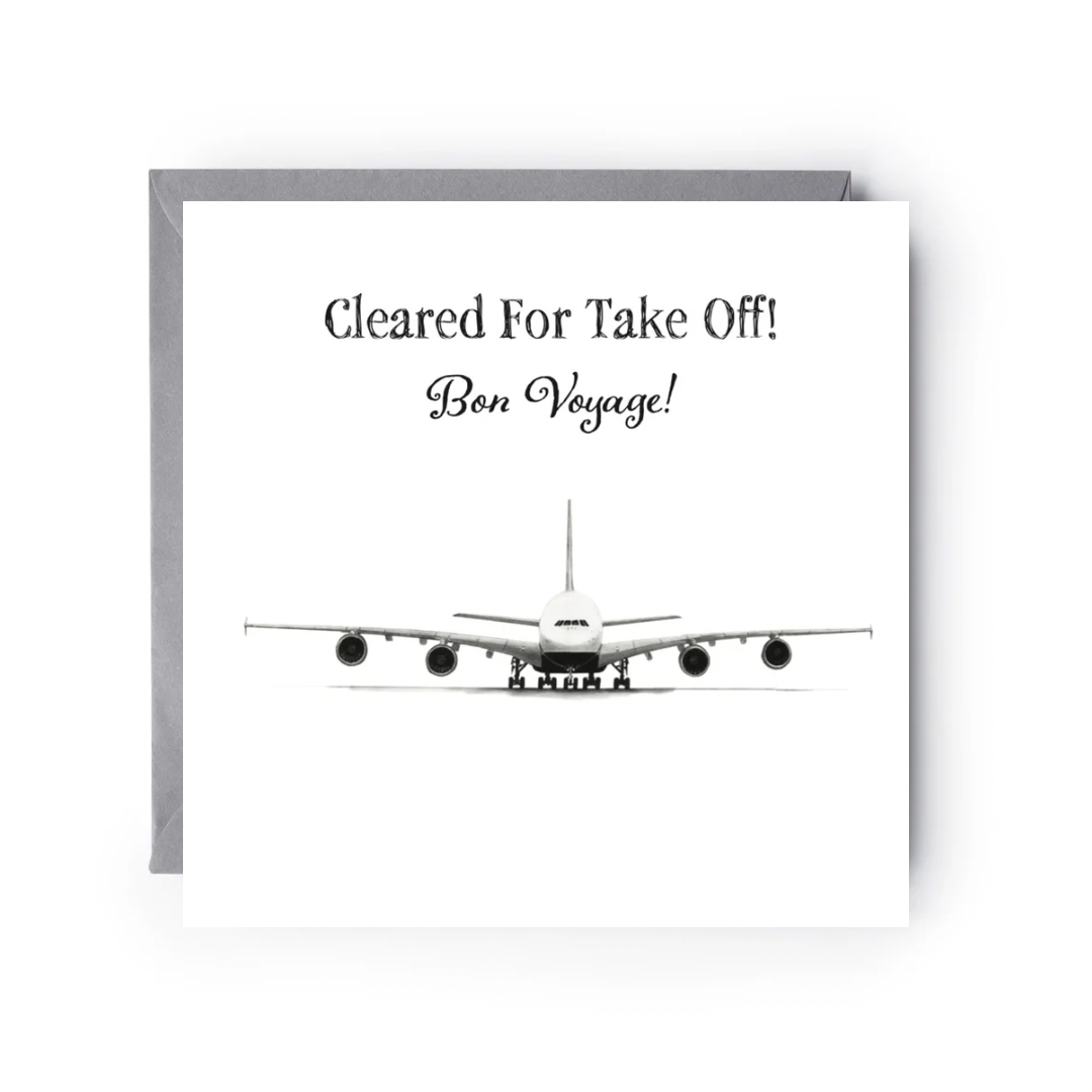 Greeting card with airplane illustration and text 'Cleared For Take Off! Bon Voyage!' on a white background