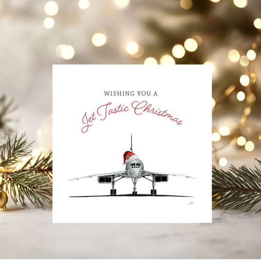 Christmas card with airplane and 'Jet Tastic Christmas' text, surrounded by festive lights and decorations.
