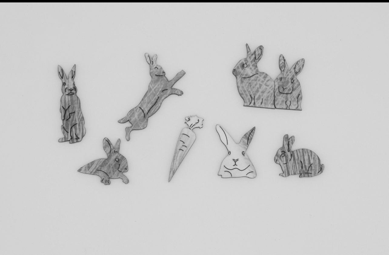 "Jigsaw pieces of the Bellatrix the Bunny Countryside Puzzle from Libra Fine Arts, featuring a detailed black and white hand-drawn bunny illustration. A charming and engaging puzzle for nature lovers."