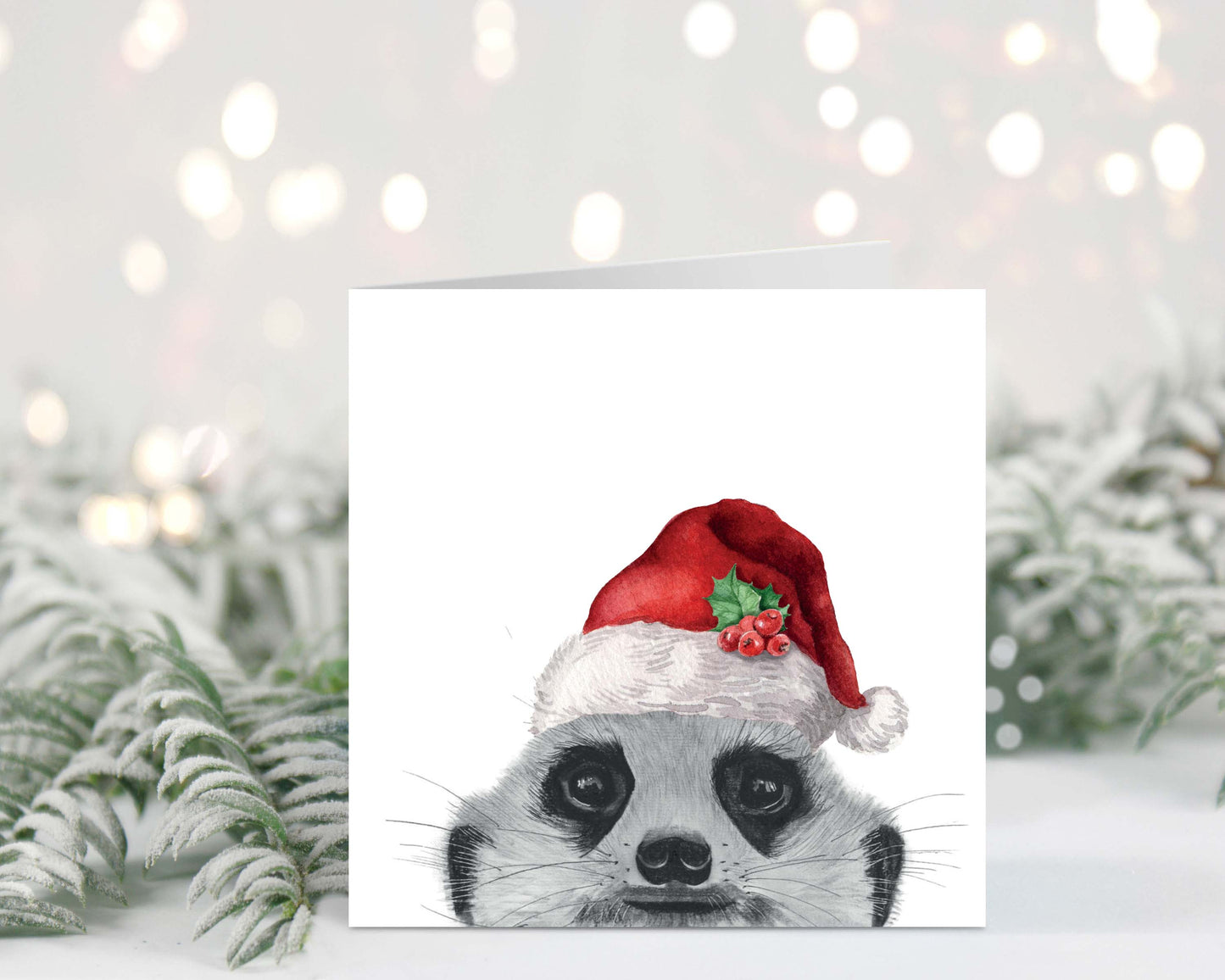 "Festive Christmas card featuring Myra the peeking meerkat wearing a Santa hat, hand-drawn illustration."