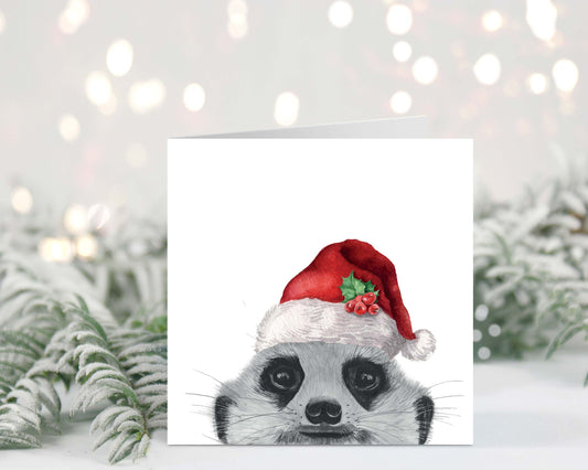 "Festive Christmas card featuring Myra the peeking meerkat wearing a Santa hat, hand-drawn illustration."