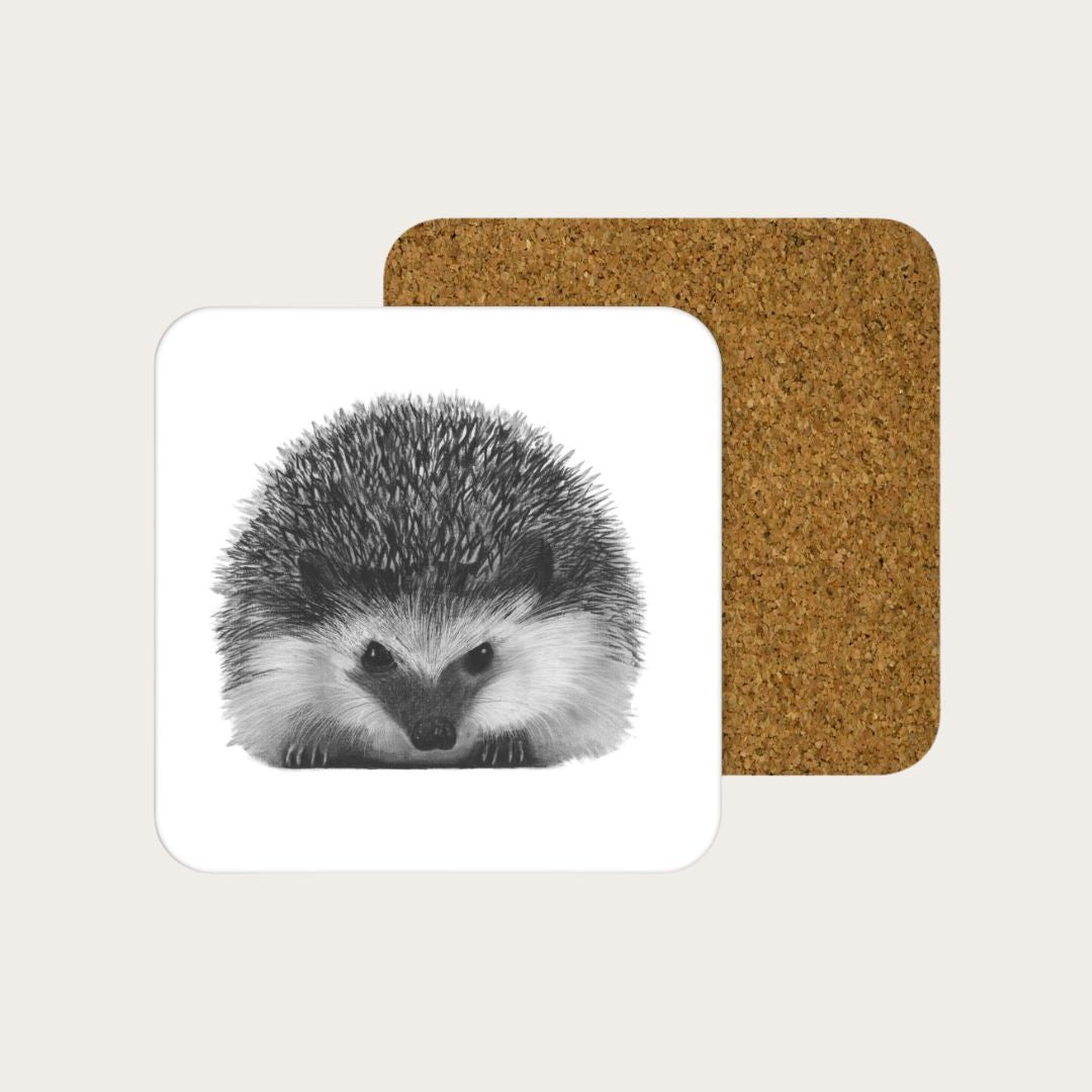 Add a touch of nature-inspired charm to your home with the Persei the Hedgehog drinks coaster. Featuring a detailed illustration of Persei the hedgehog, this coaster is crafted from durable melamine with an eco-friendly eucalyptus core and a cork backing, ensuring both longevity and surface protection. Measuring 10x10cm, it's proudly manufactured in the UK. Available individually or in packs of four at Libra Fine Arts.