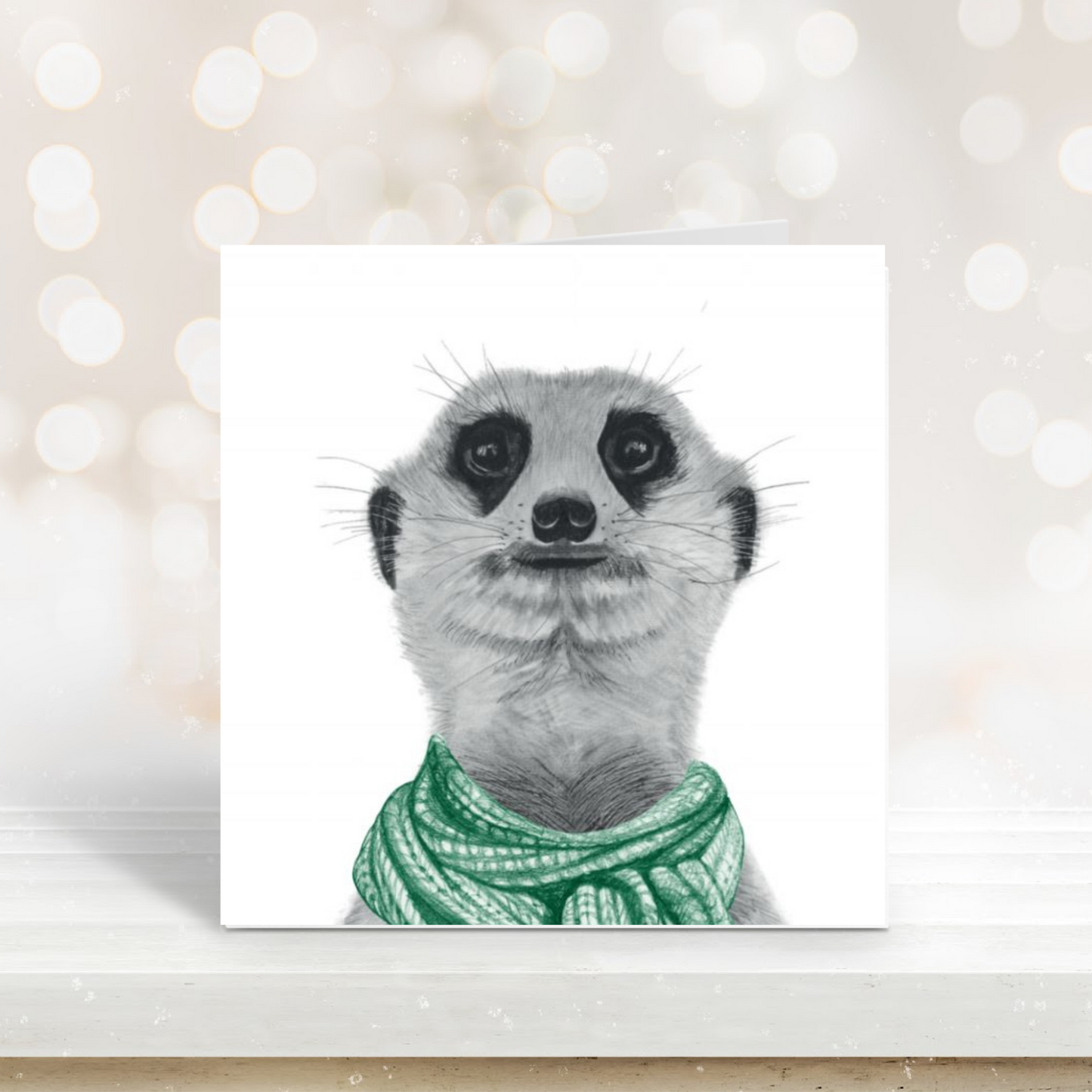 Cute illustration of a meerkat wearing a green scarf on a festive winter card.