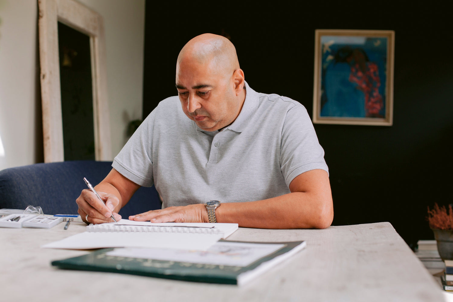 Skip from Libra Fine Arts creating a detailed hand-drawn design using charcoal and graphite in the studio.