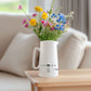 Hand-drawn 747 jumbo jet design on a ceramic jug, elegantly filled with fresh wildflowers. A charming piece from the Libra Fine Arts collection, blending aviation heritage with natural beauty.