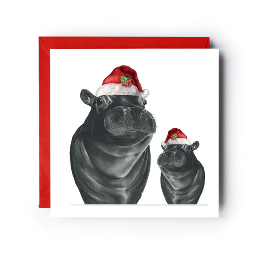 Carina and Baby Hippo Festive Red Hat Christmas Card — card with red envelope