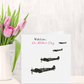 Greeting card with vintage airplane illustrations and 'With Love, On Mother's Day' text next to a vase of pink tulips.