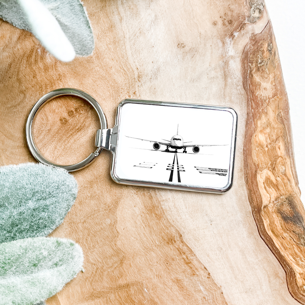 Silver Boeing 787 metal keyring featuring a detailed airplane design on a sturdy keyring loop