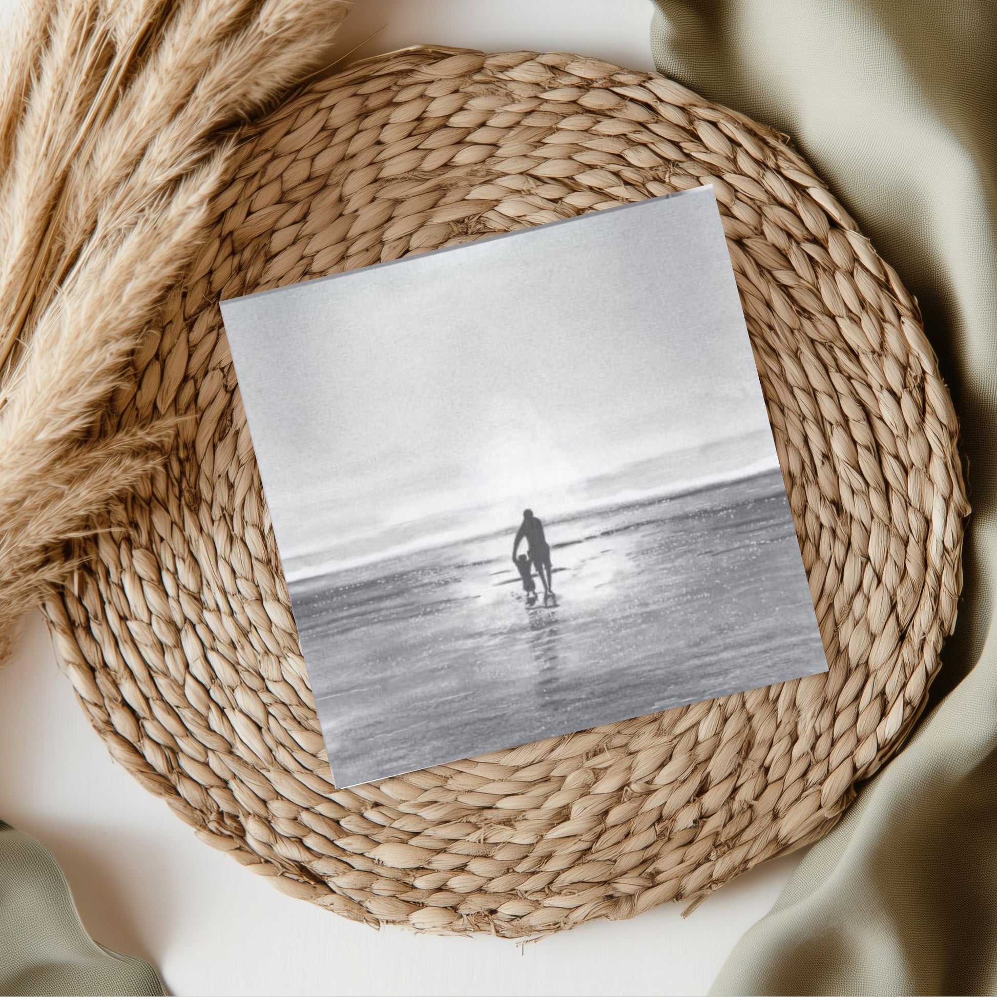 A heartwarming greeting card illustrating a parent and child walking hand-in-hand along the seashore, capturing a moment of love and togetherness