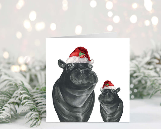 Carina the hippo and her baby, both wearing festive red hats, featured on this heartwarming Christmas greeting card