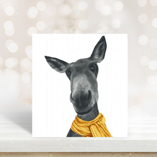 Winter donkey illustration wrapped in a warm scarf on a seasonal greeting card.

