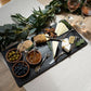 A set of 4 teaspoons from the Country Animals collection, each with unique animal designs on the handles, displayed alongside a serving board of cheese and chutneys. The teaspoons are in use, adding a rustic, charming touch to the spread with their intricate animal detailing