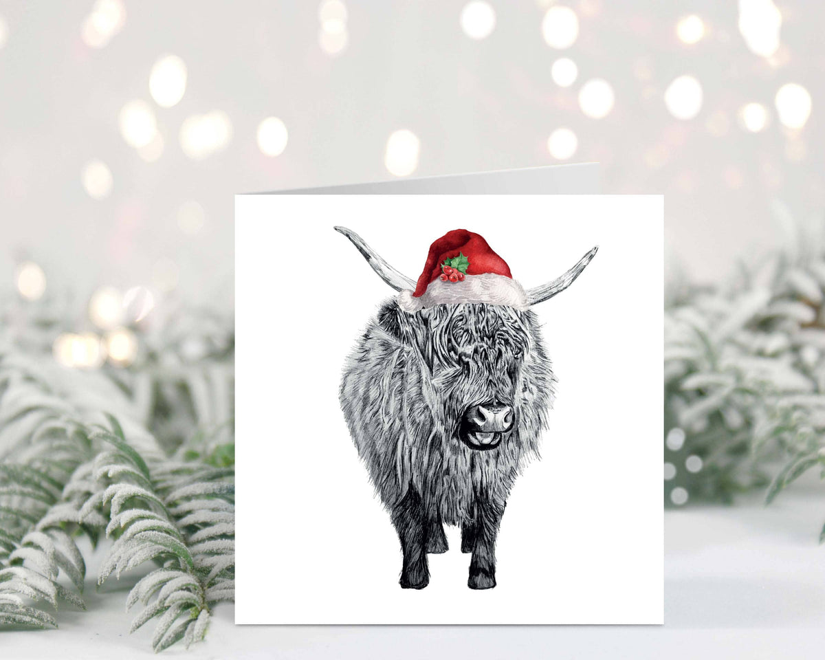 Send festive cheer with this adorable Baby Highland Cow Christmas Card. Perfect for animal lovers, this hand-drawn design features a cute baby Highland Cow in a Santa hat, making it the perfect card for friends, family, or anyone who loves the countryside
