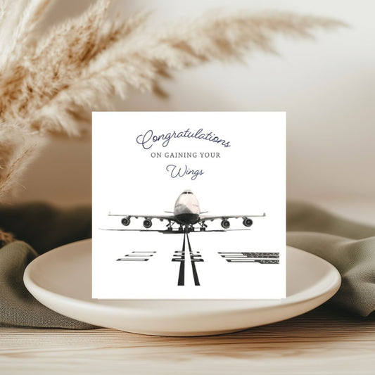 This aviation-inspired 'Congratulations on Gaining Your Wings' greeting card showcases a beautifully hand-drawn 747 aircraft. Perfect for congratulating someone on their flight milestone or aviation achievement."

