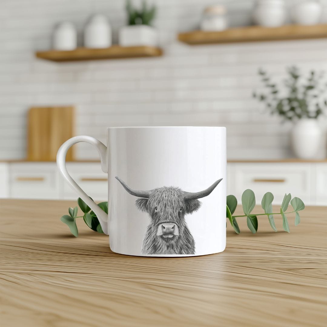 Bone china mug featuring Corvus the hand-drawn Highland cow, ideal for countryside lovers.