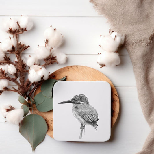 A high-quality coaster featuring a detailed hand-drawn illustration of Delpheus the Kingfisher, adding a touch of wildlife elegance to your home decor. Measuring 10x10cm, this UK-made coaster boasts a durable melamine surface, an eco-friendly eucalyptus base, and a cork backing to protect your furniture. An ideal gift for bird enthusiasts and collectors. ​
Libra Fine Arts