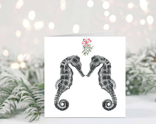 Diya the seahorse and friend under festive mistletoe on a charming Christmas greeting card