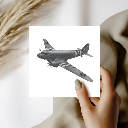 Hand holding a card with an illustration of an airplane against a neutral background