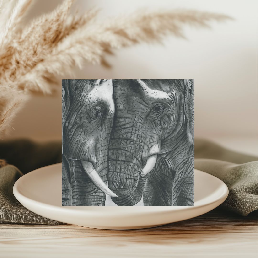 A beautifully hand-illustrated greeting card featuring a tender moment between two elephants, perfect for sending heartfelt messages to nature enthusiasts and animal lovers. Printed on 300gsm recycled cardstock, it includes a recyclable grey envelope and is left blank inside for your personal message. Designed and printed in the UK. Available at Libra Fine Arts