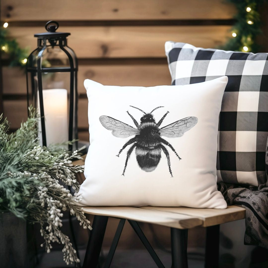 Soft faux suede bee cushion with hand-drawn illustration. A charming home décor piece and perfect gift for nature and wildlife lovers.