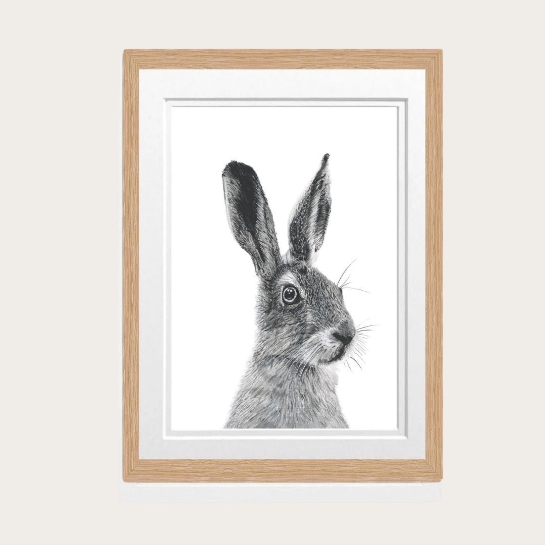 A detailed hand-drawn hare fine art print, elegantly framed in oak, perfect for nature enthusiasts and as a thoughtful gift. Available in various sizes to suit your space.