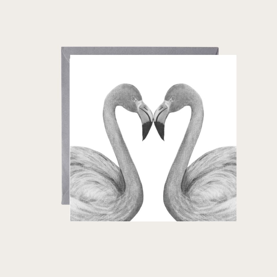 Delicate hand-drawn greeting card showcasing two flamingos creating a heart, an ideal choice for celebrating love and affection.

