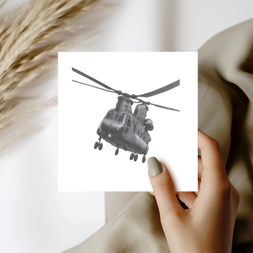 Hand holding a card with a black and white helicopter illustration on a light background