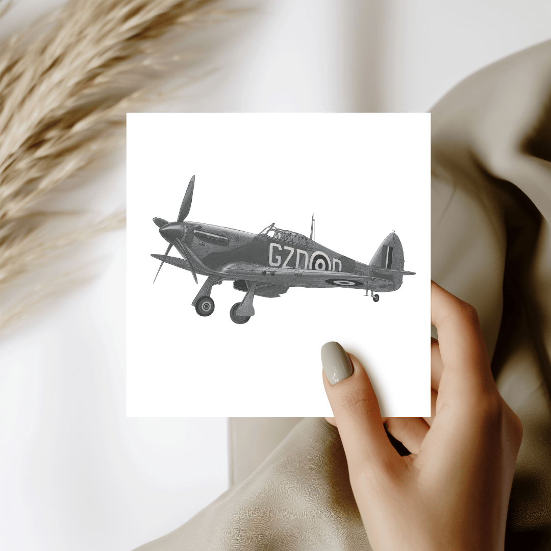 Hand holding a card with a black and white airplane illustration.