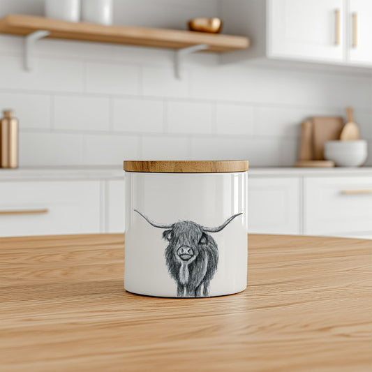 Bone china storage jar featuring a hand-drawn Highland Cow illustration, perfect for keeping tea, coffee, sugar, or biscuits fresh and stylish.