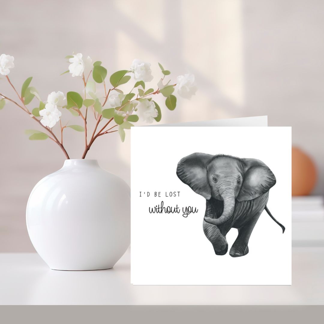 A beautifully hand-drawn baby elephant greeting card, featuring the heartfelt message "I'd Be Lost Without You." Printed on Libra Fine Arts FSC-certified cardstock, this eco-friendly card is perfect for expressing love, gratitude, or appreciation. Ideal for Mother’s Day, Father’s Day, anniversaries, or just because. Blank inside for a personal touch. A thoughtful wildlife-themed card for elephant lovers and animal enthusiasts.