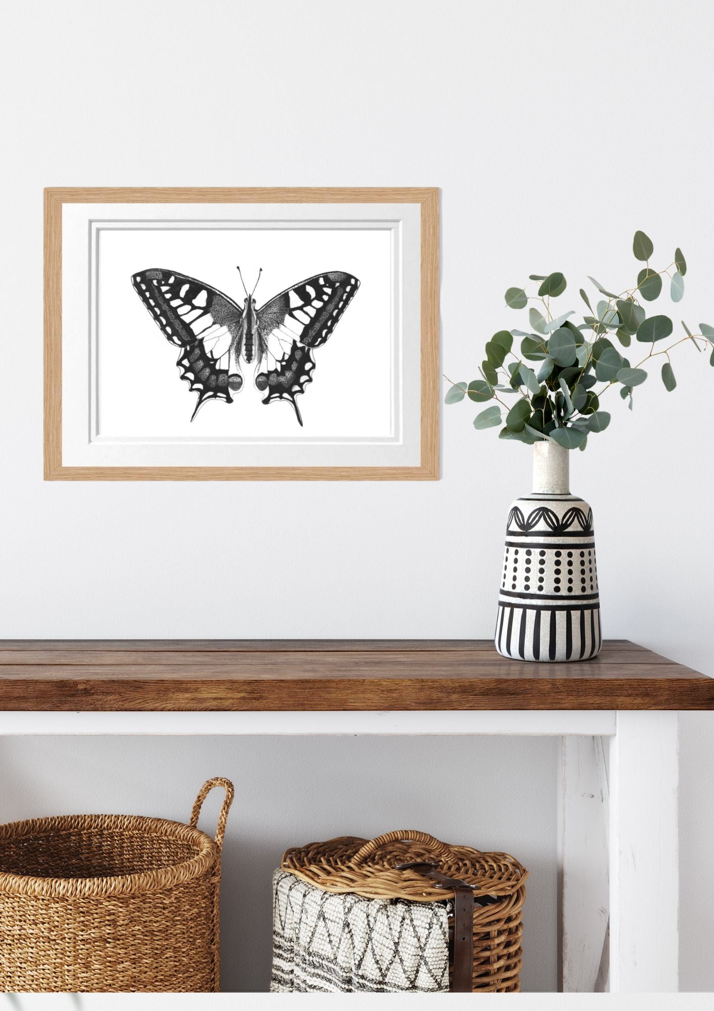 Libra_Fine_Arts_Hand_Drawn_Old_World_Swallowtail_Butterfly_Drawing_in_oak_Frame._on_the_wall_above_a_side_table_with_baskets_and_vase._The_perfect_gift_for_inscet_and_butterfly_lovers.