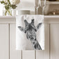 Cotton tea towel featuring Maya the Giraffe, a delightful and elegant design to brighten up your kitchen. A perfect gift for giraffe lovers and animal-themed home decor.