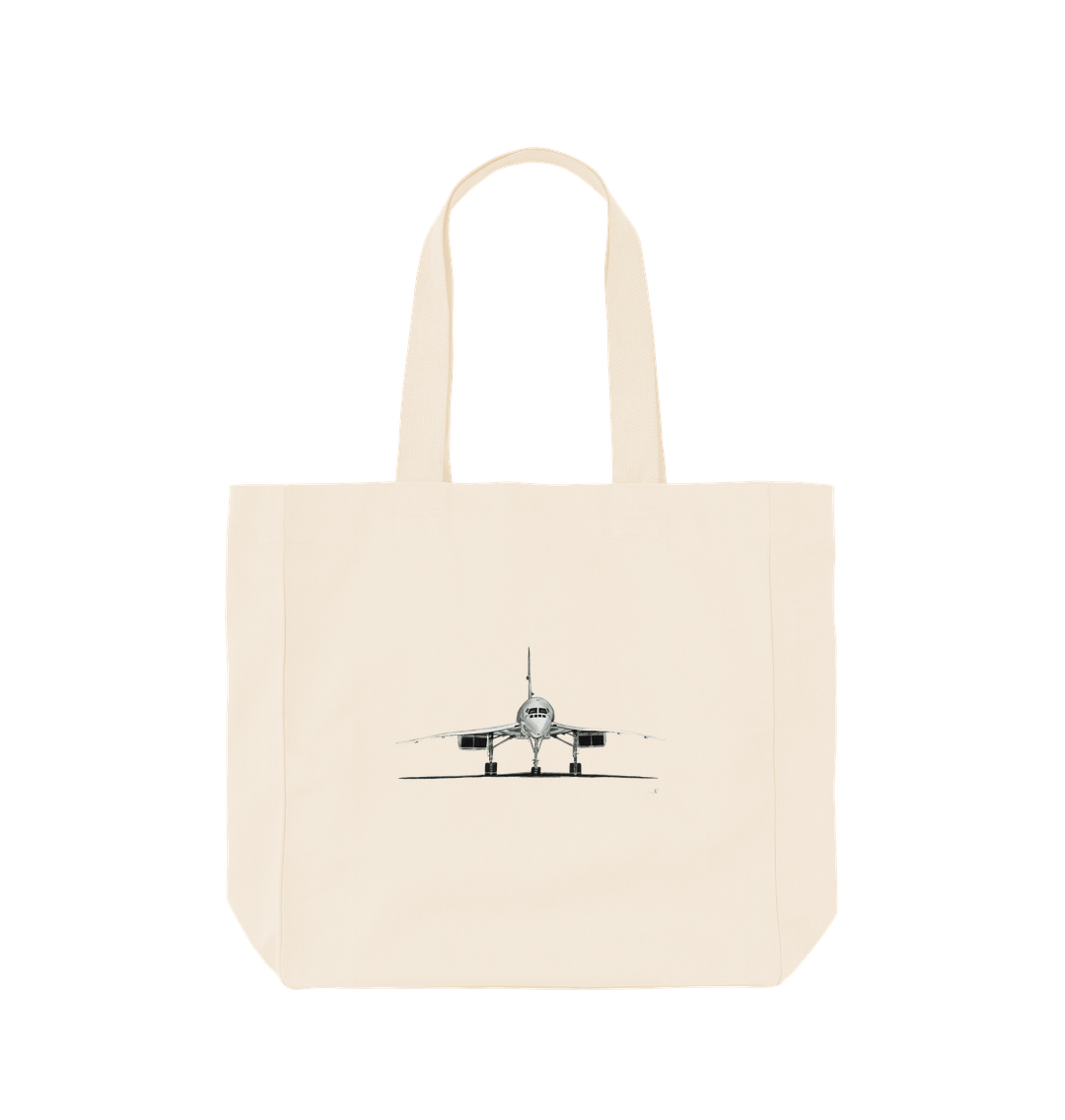 Natural Concorde Shopper Bag. This Concorde Aircraft Organic Shopper Bag is crafted from eco-friendly canvas material, featuring a detailed hand-drawn design of the iconic Concorde aircraft. The sturdy bag is perfect for everyday use, whether you're shopping, running errands, or carrying your essentials. With its spacious interior and durable construction, this bag offers both style and functionality. Ideal for aviation enthusiasts and those looking for a sustainable, reusable bag