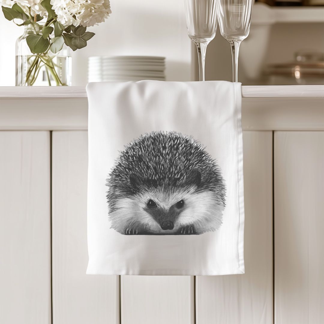 Organic tea towel featuring Persei the Hedgehog, a charming and eco-conscious addition to your kitchen. Ideal for hedgehog lovers and sustainable home decor.