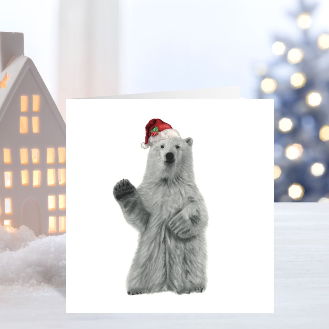 Adorable polar bear wearing a red Santa hat on this festive Christmas card, bringing holiday joy.