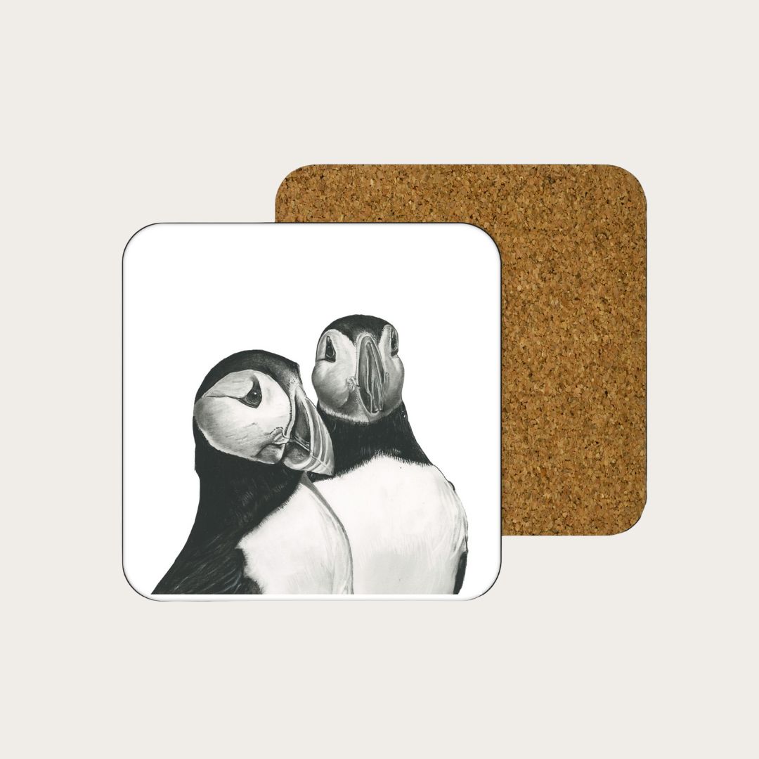 An exquisite coaster showcasing a detailed hand-drawn image of puffins, perfect for adding character to your living space. Made from high-quality, eco-friendly materials, this coaster offers both style and practicality. A must-have for fans of whimsical seabird art and coastal decor.​

