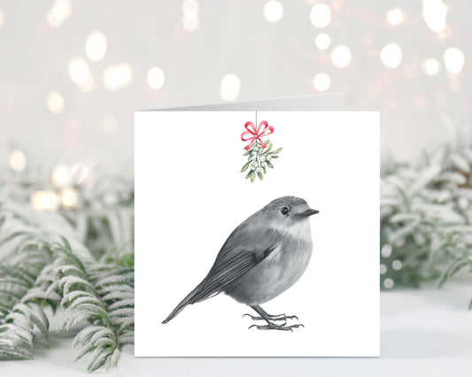 Charming robin perched under mistletoe on this festive Christmas greeting card, perfect for holiday wishes