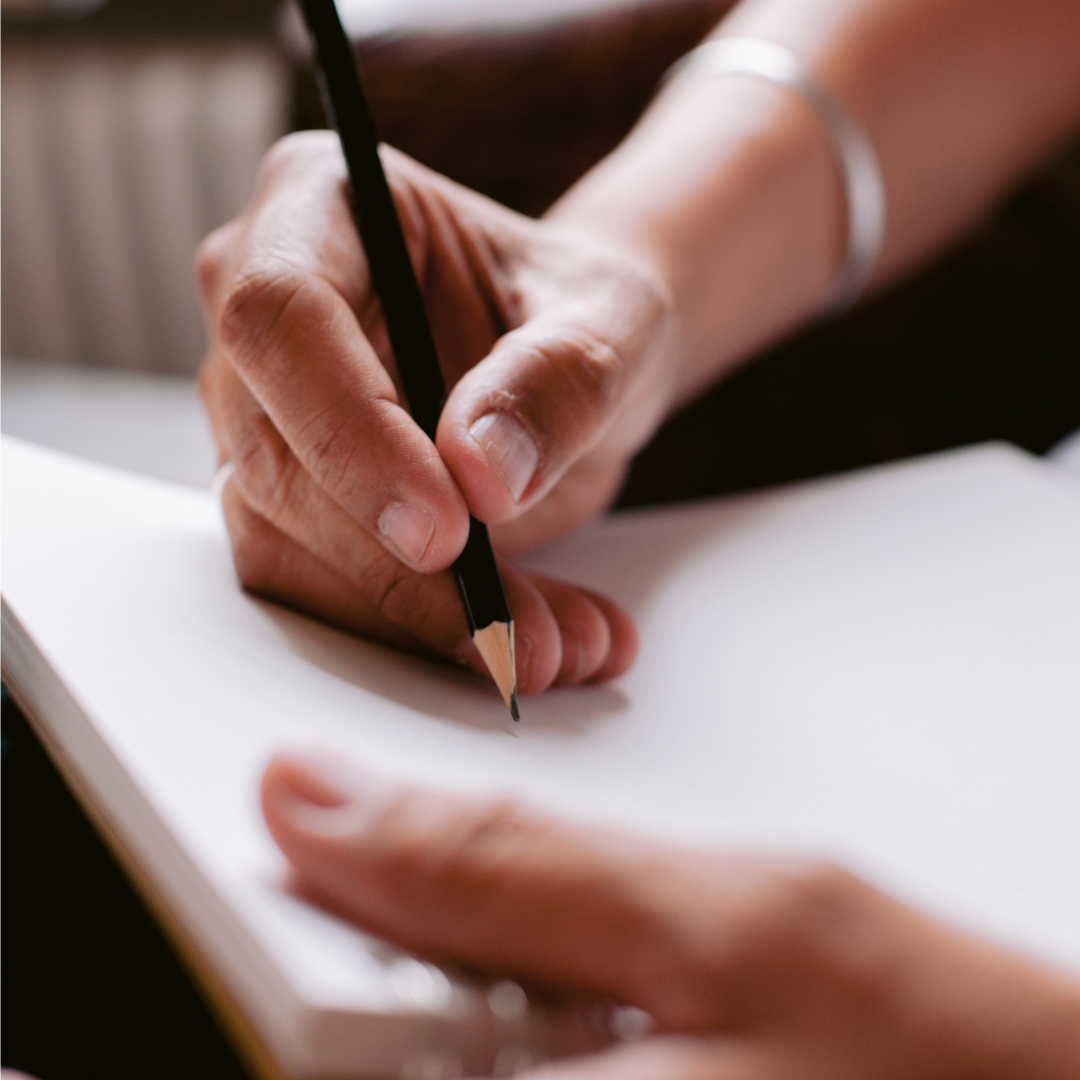 Artist Skip creating a detailed hand-drawn animal illustration at his desk in the Windsor studio, showing the artistic process behind the collection.