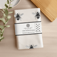 Cotton tea towel featuring hand-drawn bees by Libra Fine Arts